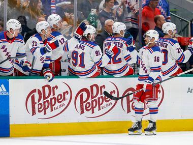 New York Rangers center Vincent Trocheck (16) celebrates with teammates after scoring a goal...