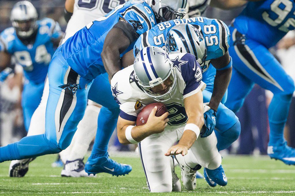 Dallas Cowboys quarterback Tony Romo (9) is sacked by Carolina Panthers outside linebacker Thomas Davis (58) during the second half of an NFL football game at AT&T Stadium on Thanksgiving Day, Thursday, Nov. 26, 2015, in Arlington. Romo left the game after re-injuring his left shoulder on the play. (Smiley N. Pool/The Dallas Morning News)