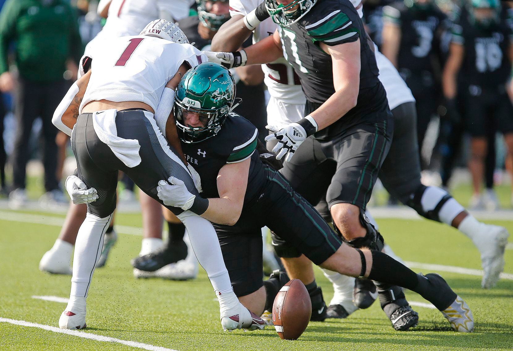 Prosper High School defensive lineman Dylan Hinshaw (8) causes a fumble with a hit put on...