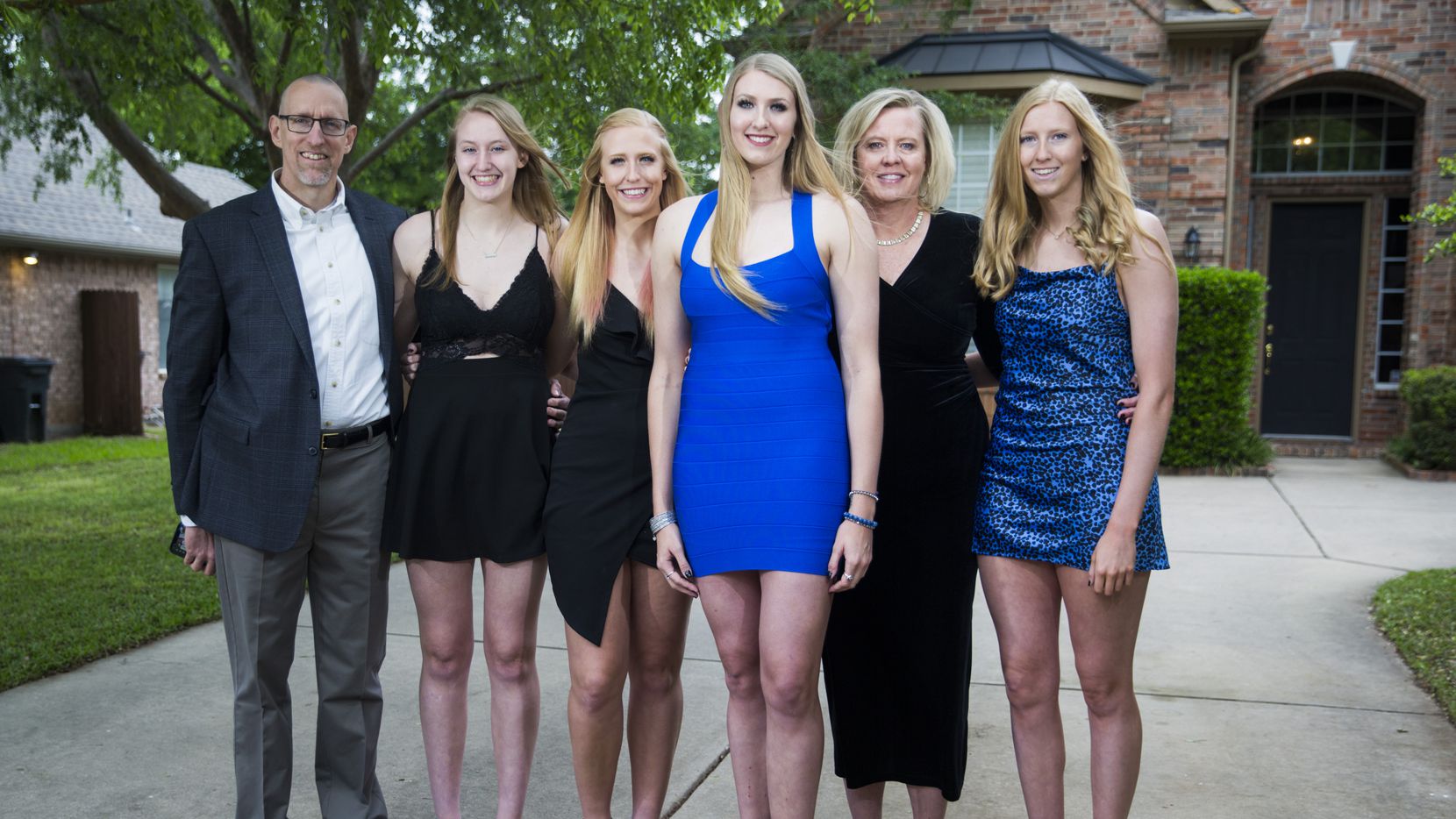 Basketball player Lauren Cox (center) poses for a photo with her family outside their home...
