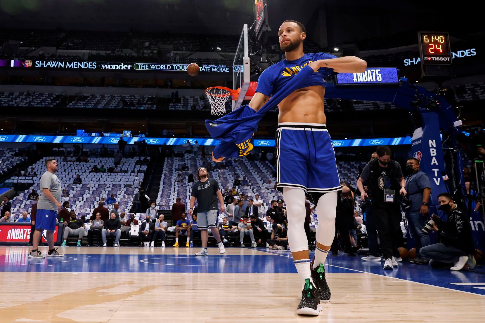 Golden State Warriors guard Stephen Curry (30) removes his shirt during warmups before...