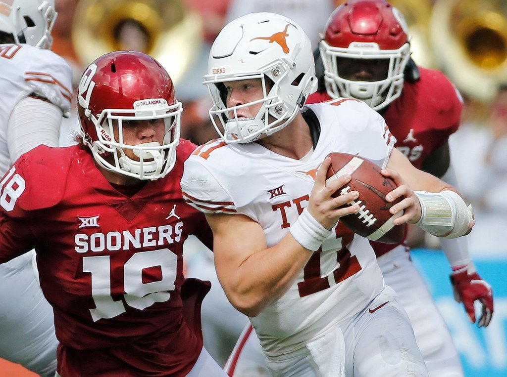 Texas Longhorns quarterback Sam Ehlinger (11) rolls out away from pressure from Oklahoma Sooners linebacker Curtis Bolton (18) during the University of Texas Longhorns vs. the Oklahoma Sooners NCAA football game at the Cotton Bowl in Dallas on Saturday, October 6, 2018. (Louis DeLuca/The Dallas Morning News)