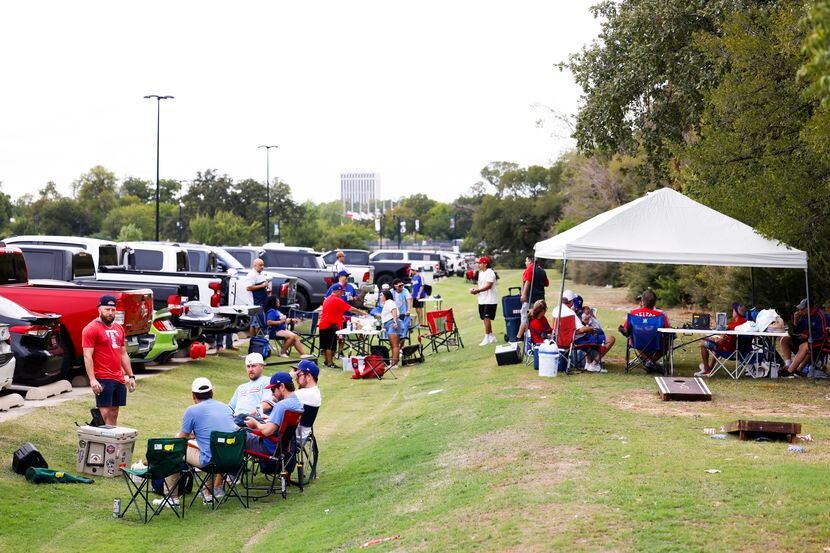 Fans tailgate outside of the Globe Life Field before Game 3 of an American League Divisional...