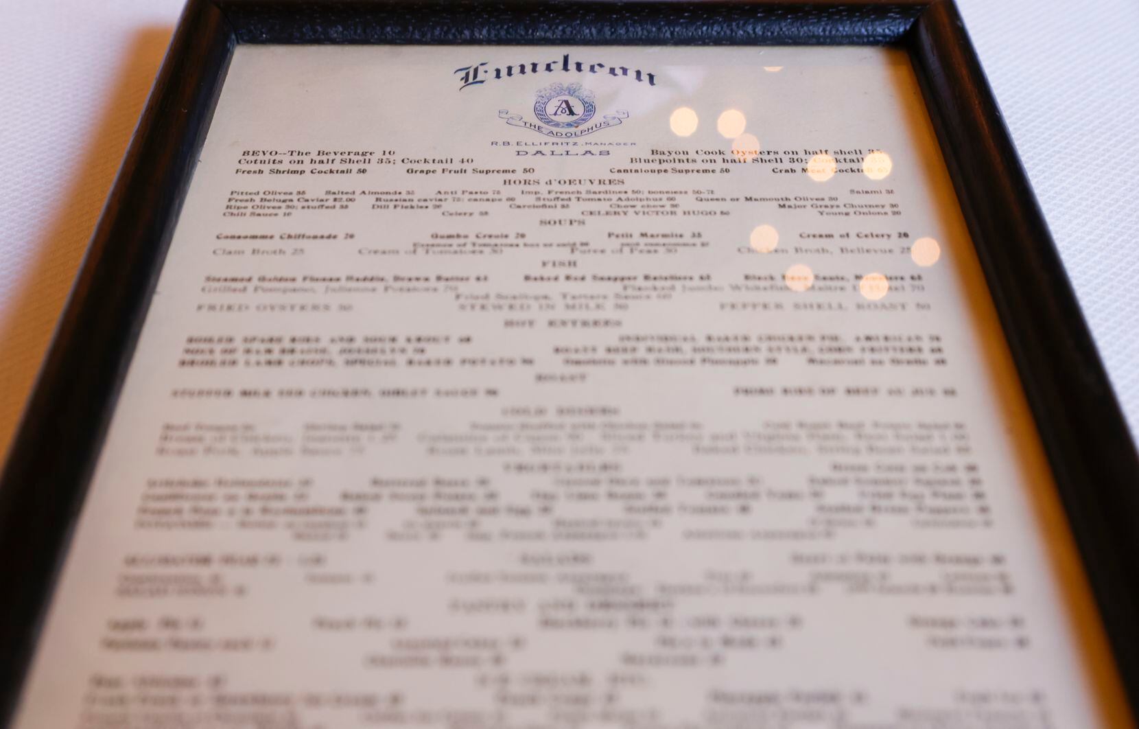 A framed archived luncheon menu at the Adolphus Hotel in Dallas on Thursday, Oct. 13, 2022.