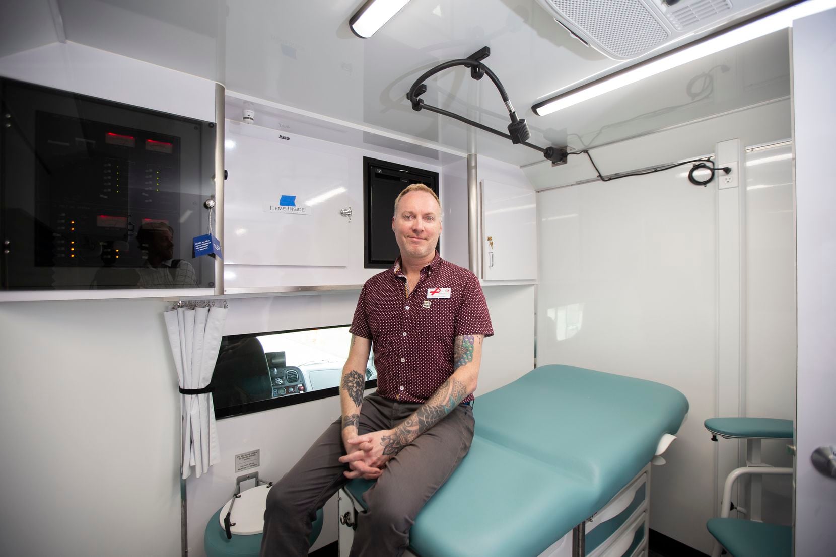 Timo Cervantez, mobile testing unit coordinator at Resource Center, is shown in an exam room inside the SexyHealth HIV testing mobile unit.
