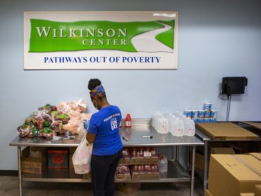 Get Shift Done worker Shkoryah Carthen prepares a bag of food at the Wilkinson Center in Dallas. Carthen, a former server at Bob's Steak & Chop House, says working for Get Shift Done helps take some weight off her shoulders while helping others.