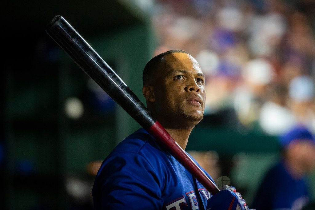 Texas Rangers designated hitter Adrian Beltre holds a bat in the dugout during the eighth...