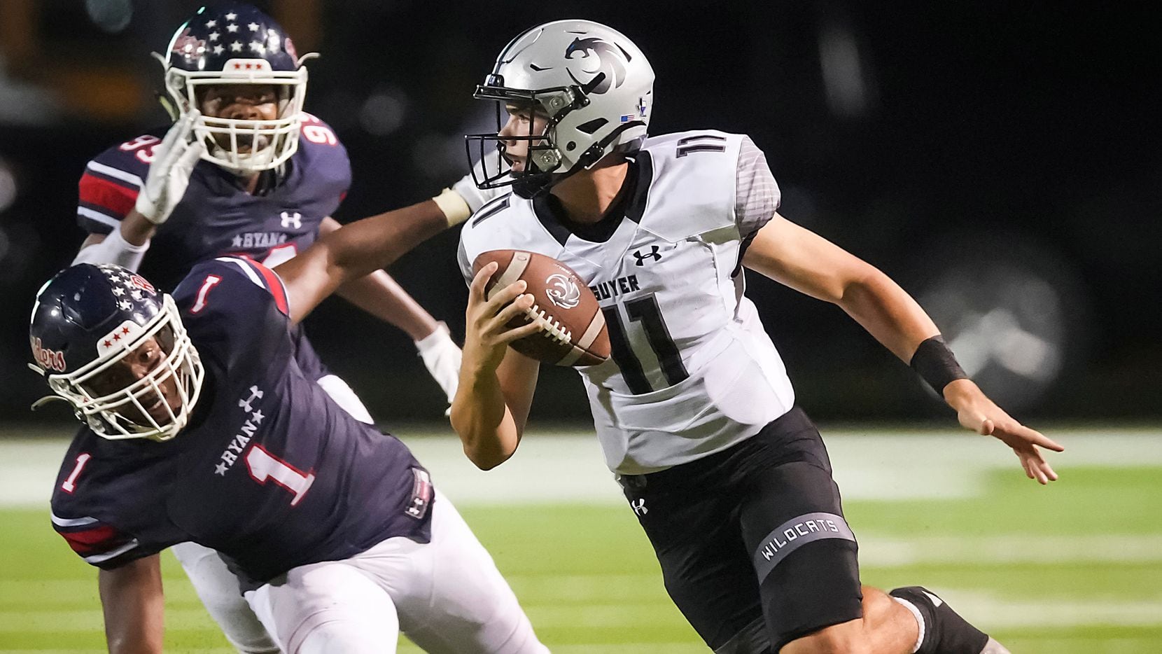 Denton Guyer quarterback Jackson Arnold (11) scrambles away from Denton Ryan defensive lineman MarQuice Hill (1) during the second half of a high school football game on Friday, Sept. 3, 2021, in Denton. Guyer won the game 14-7 in overtime. (Smiley N. Pool/The Dallas Morning News)