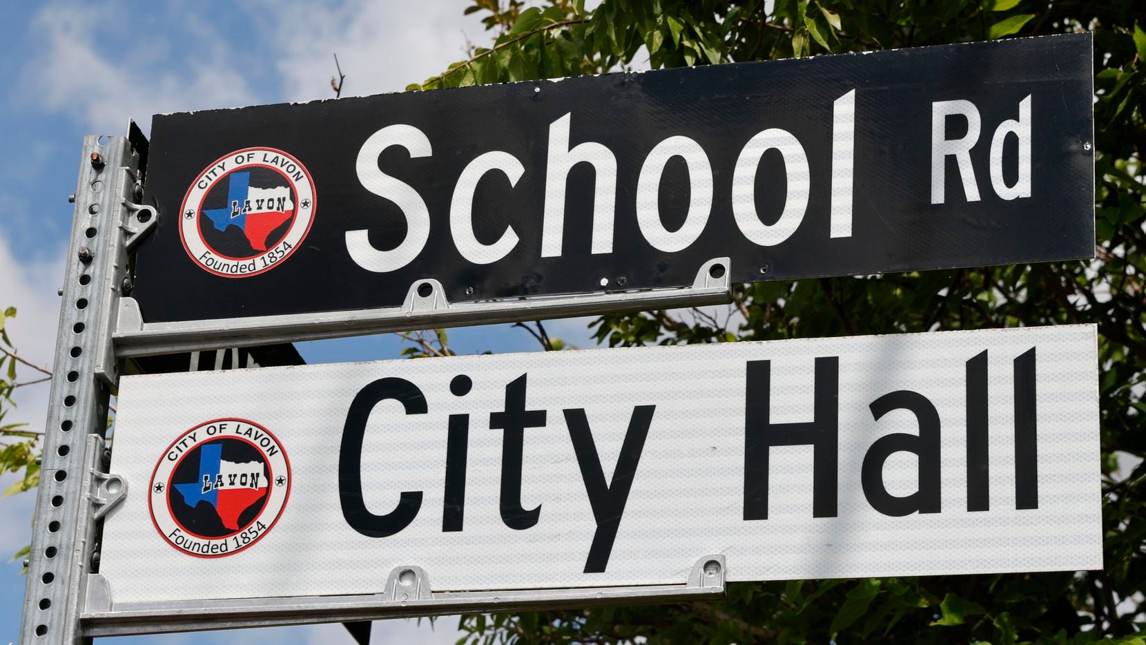A street sign for School Road and the City Hall is pictured in Lavon on Aug. 24.