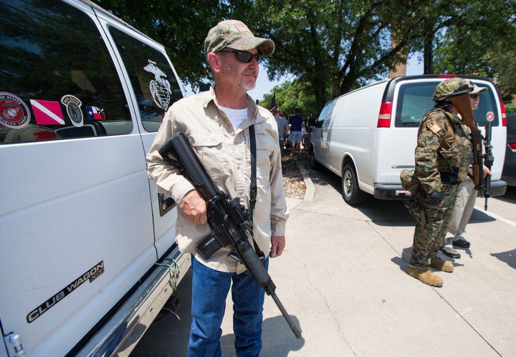 Anti-Shariah protester Jim Rodgers, of Fort Worth, open carries a rifle during an...