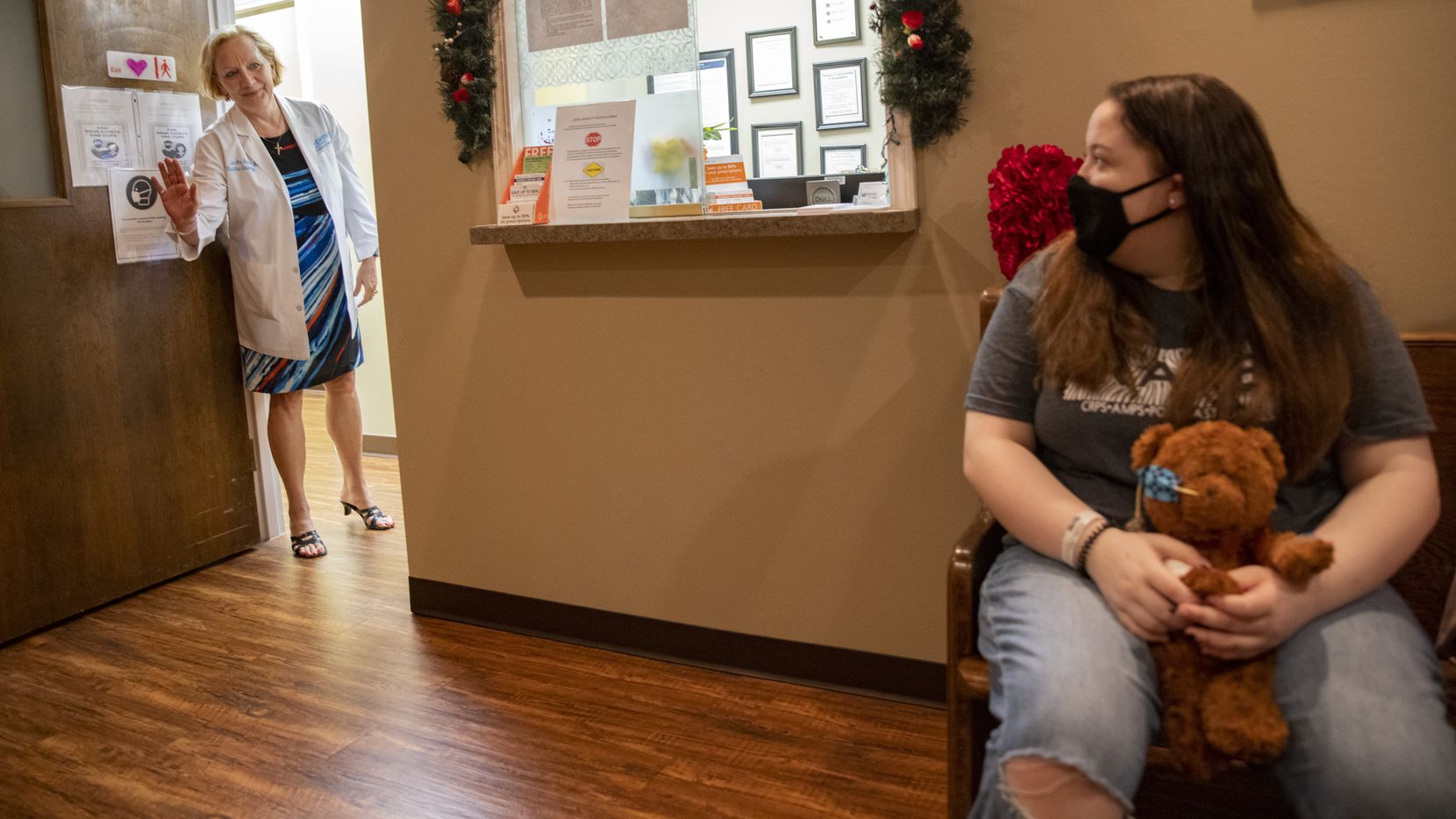 Dr. Lee Pearse waves to Lacie Mitchell, 15, in the waiting room for Dr. Pearse's office on...