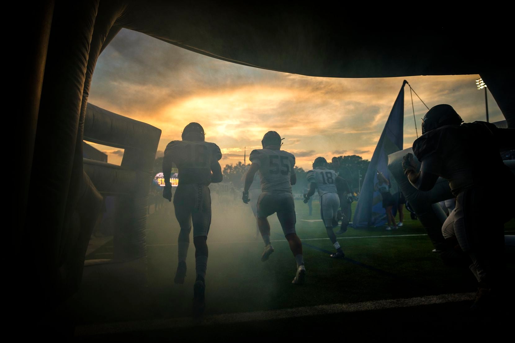 Frisco Lone Star</bold> cornerback Sherman Steptoe (16), offensive lineman Braden Grove (55) and wide receiver Marvin Mims (18) take the field to face Highland Park in a high school football game as the sun sets on Highlander Stadium in University Park.