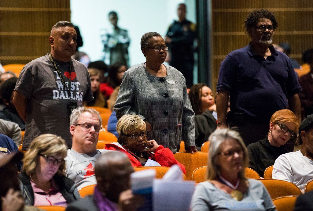 Supporters stand as Ronnie Mestas speaks to DISD trustees before they voted on several...