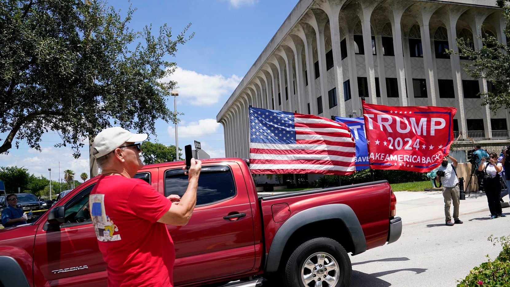 A vehicle with flags in support of Donald Trump drives outside of the Paul G. Rogers Federal...
