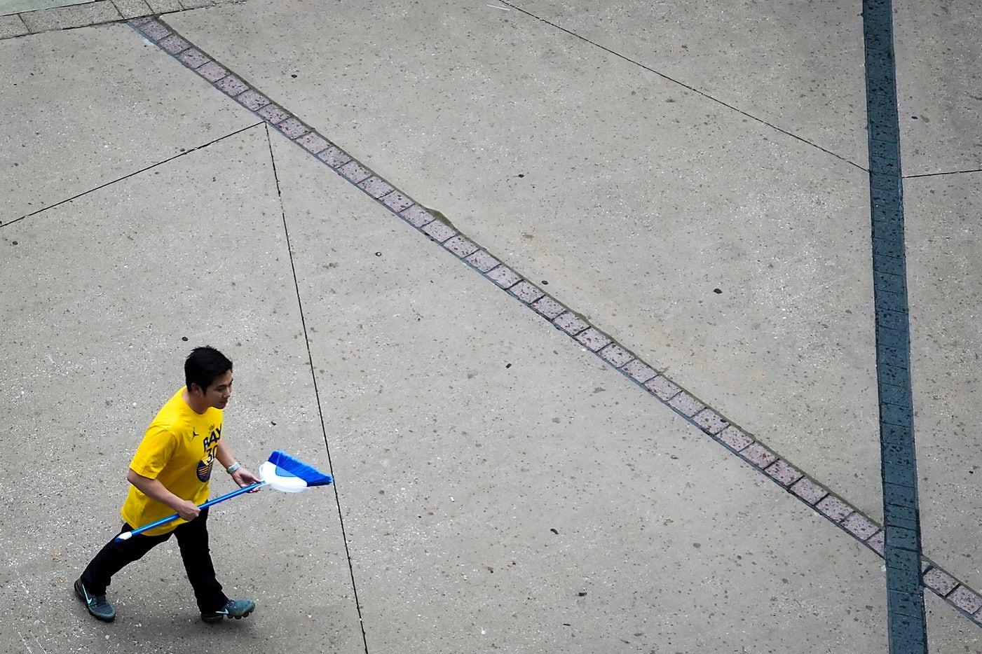 A Golden State Warriors fan arrives at the arena with a broom before Game 4 of the NBA...