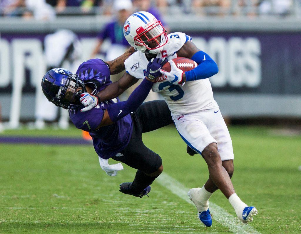 Southern Methodist Mustangs wide receiver James Proche (3) is pushed out of bounds by TCU...
