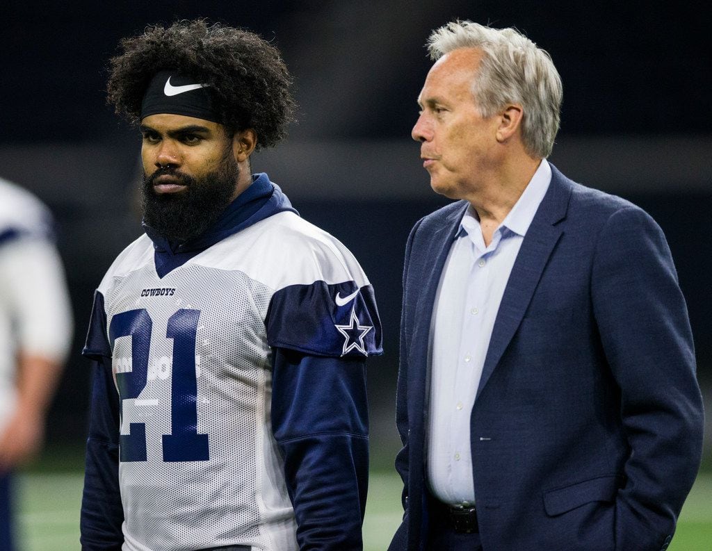 Dallas Cowboys running back Ezekiel Elliott (21) talks with Rich Dalrymple, senior vice president of public relations and communications, during a Dallas Cowboys OTA practice on Wednesday, May 22, 2019 at The Star in Frisco. (Ashley Landis/The Dallas Morning News)