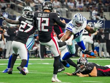 Dallas Cowboys defensive end Dorance Armstrong (92) blocks a punt by Atlanta Falcons punter Dustin Colquitt (12) during the first half of an NFL football game at AT&T Stadium on Sunday, Nov. 14, 2021, in Arlington.