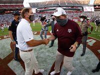 Nick Saban of the Alabama Crimson Tide shakes hands with Jimbo Fisher of the Texas A&M...