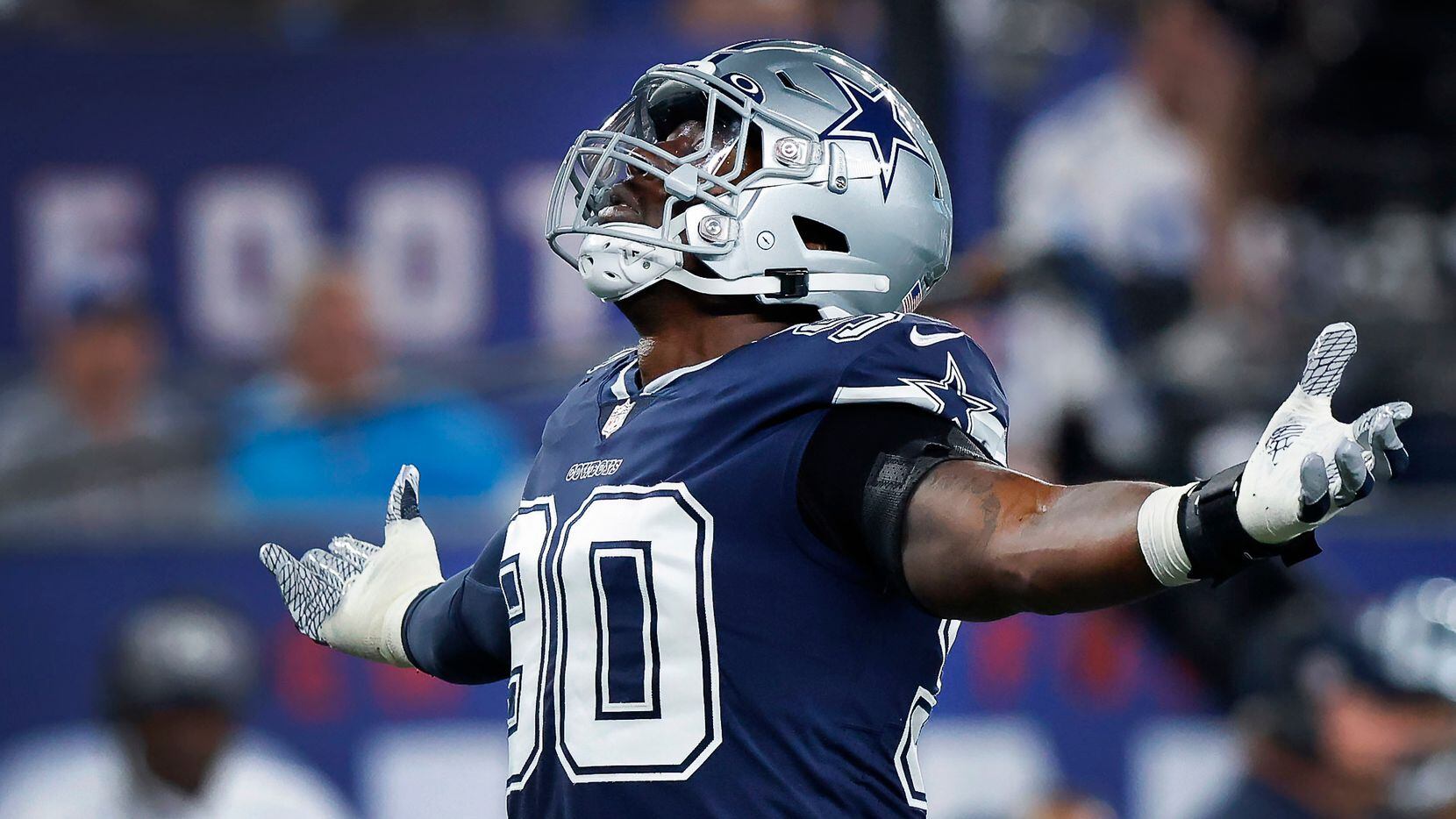 Dallas Cowboys defensive end DeMarcus Lawrence (90) celebrates his first quarter sack of New...