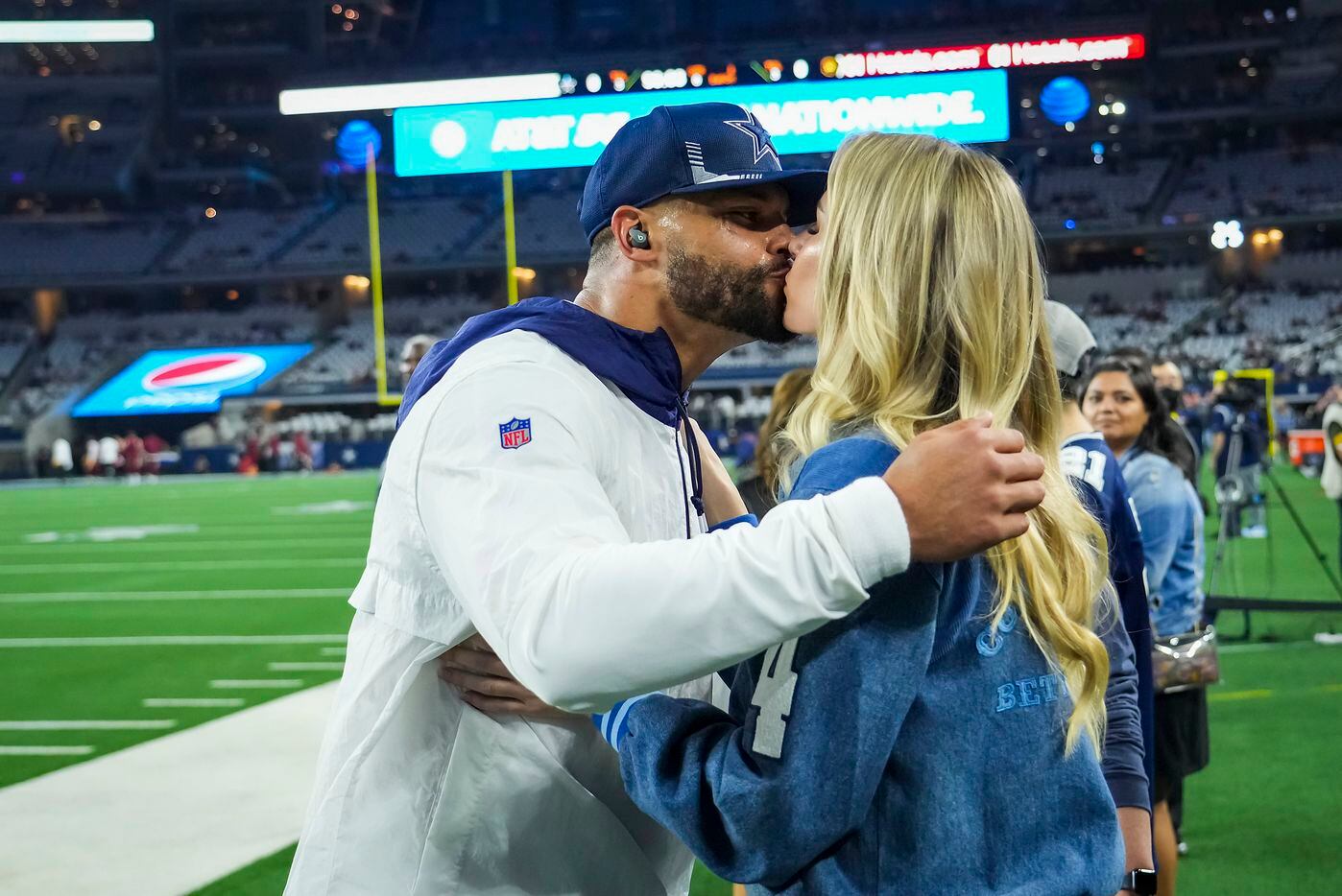 Dallas Cowboys quarterback Dak Prescott kisses his girlfriend Natalie Buffett before an NFL football game against the Washington Football Team at AT&T Stadium on Sunday, Dec. 26, 2021, in Arlington.