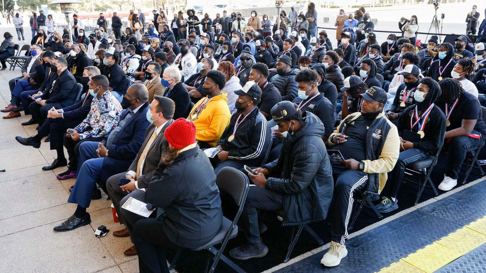 The South Oak Cliff football team sit with members of the Dallas City Council during a ceremony recognizing South Oak Cliff’s UIL Class 5A Division II football state championship at Dallas City Hall in Dallas, on Wednesday, Jan. 12, 2022.