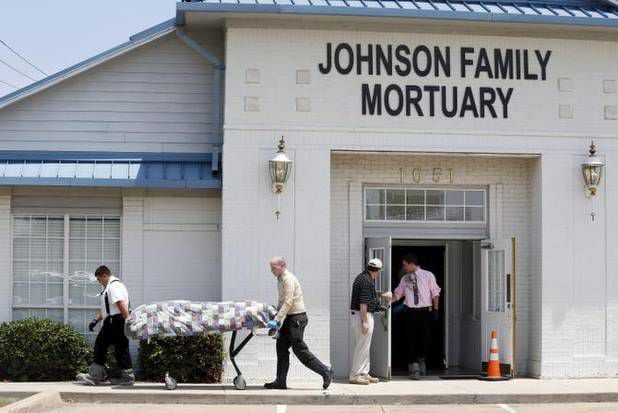 
Officials take bodies from Johnson Family Mortuary on South Handley Drive in Fort Worth. No...