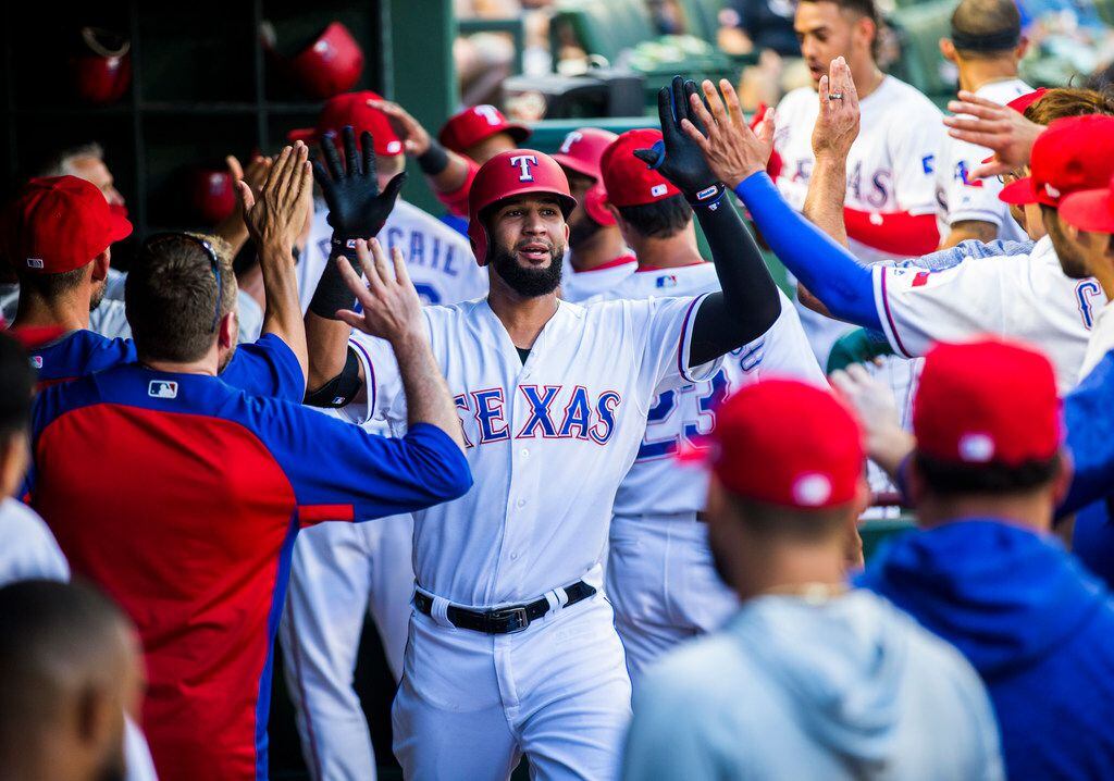 Texas Rangers right fielder Nomar Mazara (30) gets high-fives in the dugout after a home run...