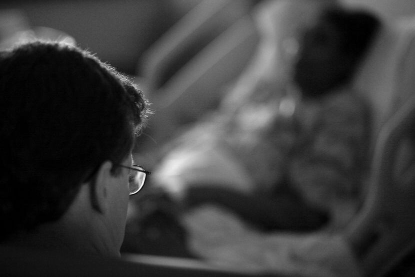 In this 2008 archival photo, Dr. Robert Fine talks with a patient about her condition.