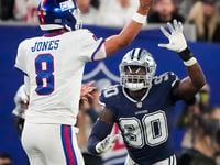 New York Giants quarterback Daniel Jones (8) throws a pass under pressure from Dallas...