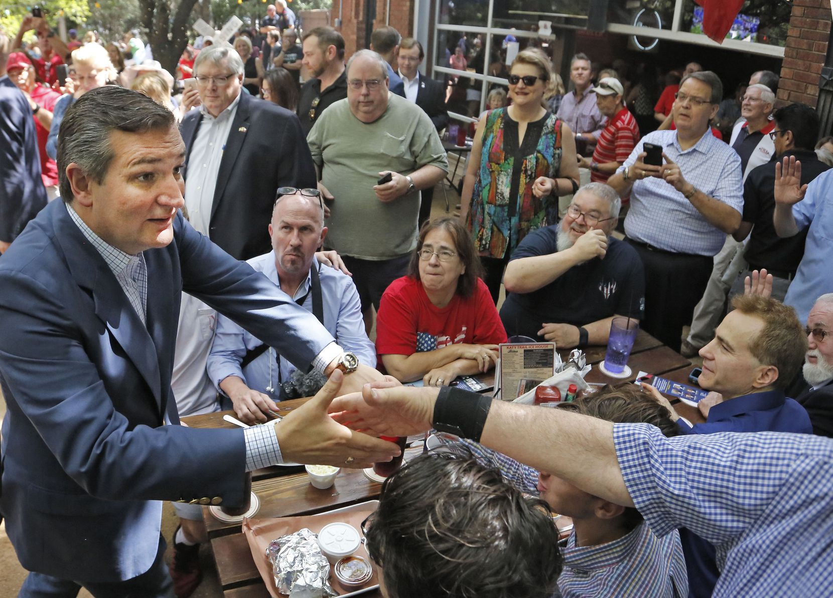 Sen.Ted Cruz works the crowd as he campaigns at the Katy Trail Ice House Outpost in Plano on...