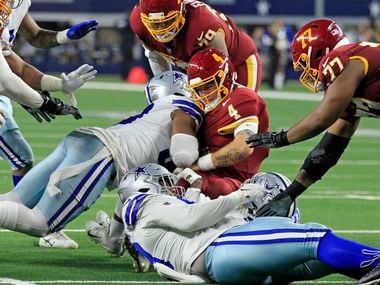 Washington Football Team quarterback Taylor Heinicke (4) is sacked by Dallas Cowboys...