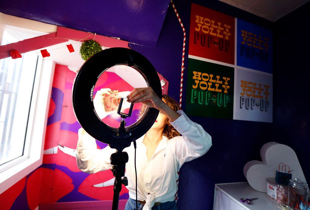 Holly Jolly Pop-Up creator Sabi Shervi mounts a smartphone into a ring light to take photos...