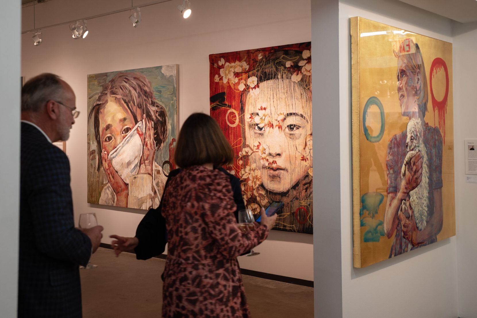 Visitors take in artwork from Turner Carroll Gallery of Santa Fe during opening night of the...