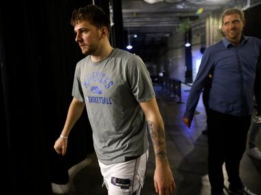 Luka Doncic walks to the locker room after visiting with former Dallas Mavericks forward...
