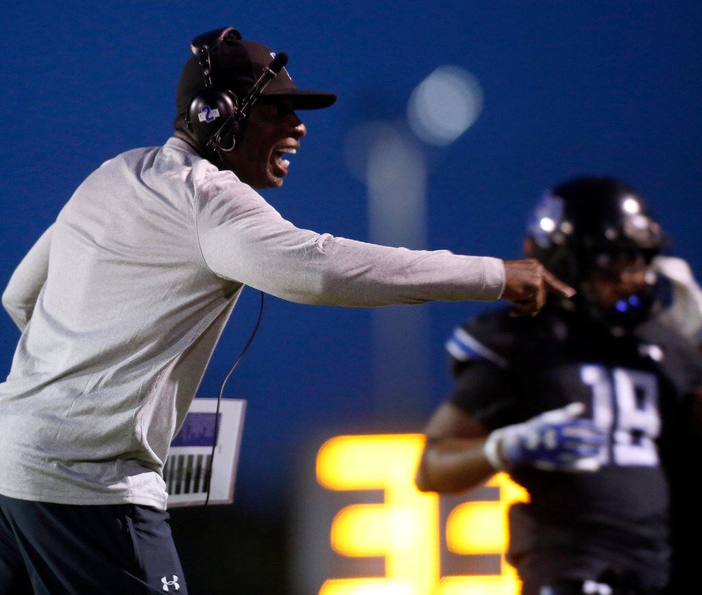 Trinity Christian Cedar Hill offensive coordinator Deion Sanders directs his players during...