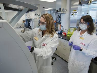 In this May 2020 photo provided by Eli Lilly, researchers prepare cells to produce possible COVID-19 antibodies for testing in a laboratory in Indianapolis. Antibodies are proteins the body makes when an infection occurs; they attach to a virus and help it be eliminated. (David Morrison/Eli Lilly via AP)
