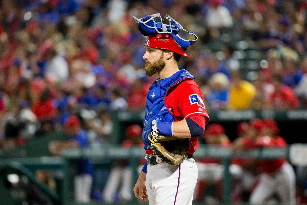 Texas Rangers catcher Jonathan Lucroy looks out onto the field during the sixth inning...