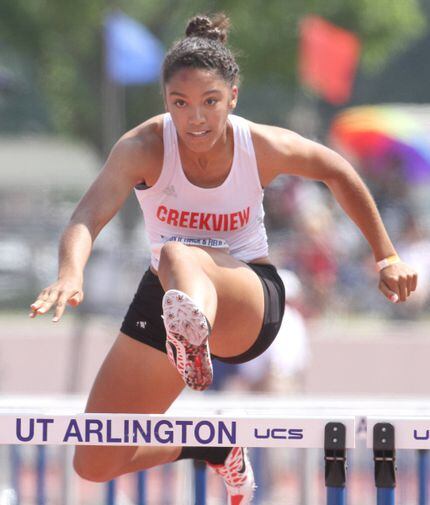 Carrollton Creekview's Melissa Gonzalez clears a hurdle on the way to her first place finish...
