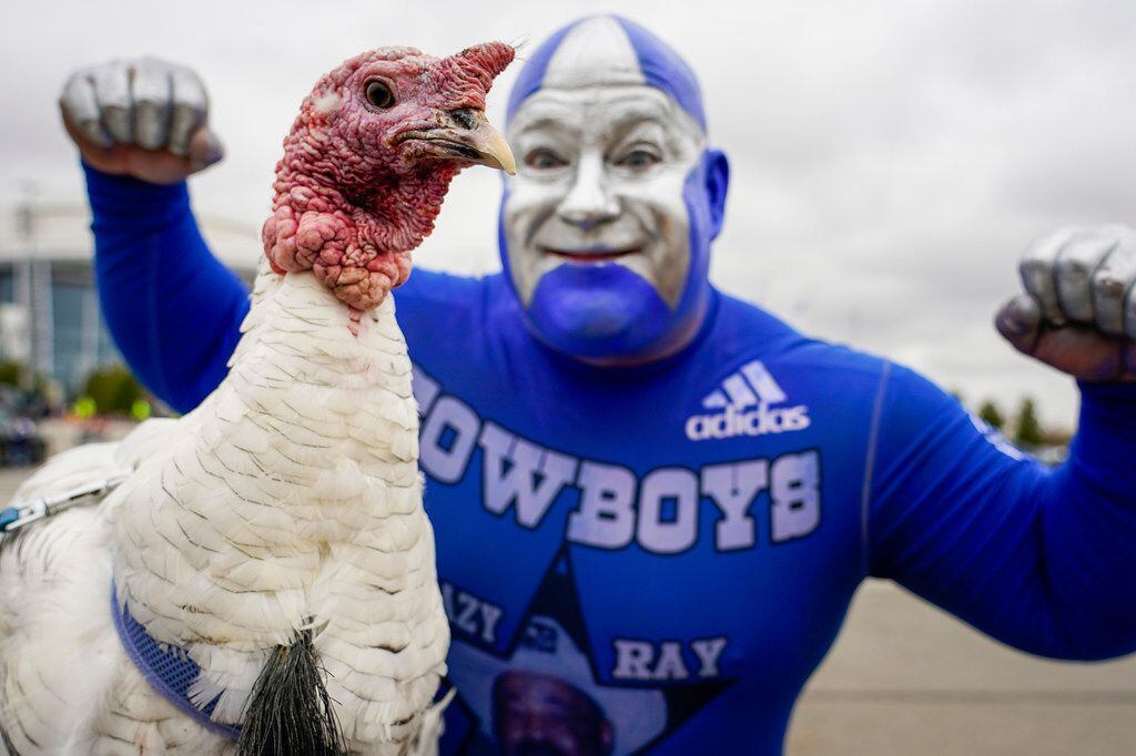 Slim Hackett poses with Tom, the Tailgate Turkey, as fans tailgate before an NFL football...
