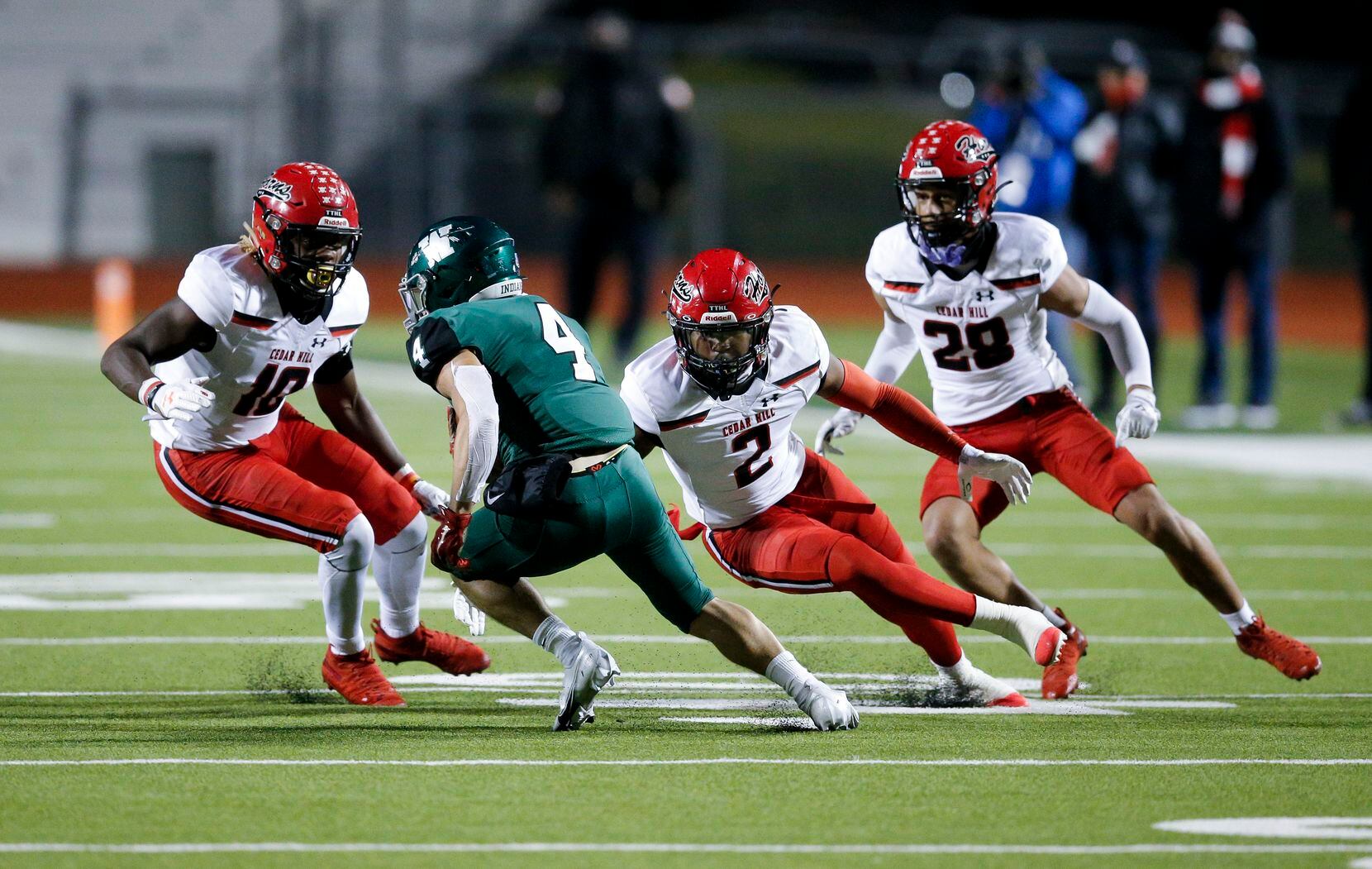 Waxahachie senior wide receiver Jaden Basham (4) looks for room against Cedar Hill senior middle linebacker Jaheim Lowe (10), senior safety Kendall Stevens (2) and junior cornerback Jalon Peoples (28) during the first half of a high school football game in Waxahachie, Friday, October 30, 2020. (Brandon Wade/Special Contributor)