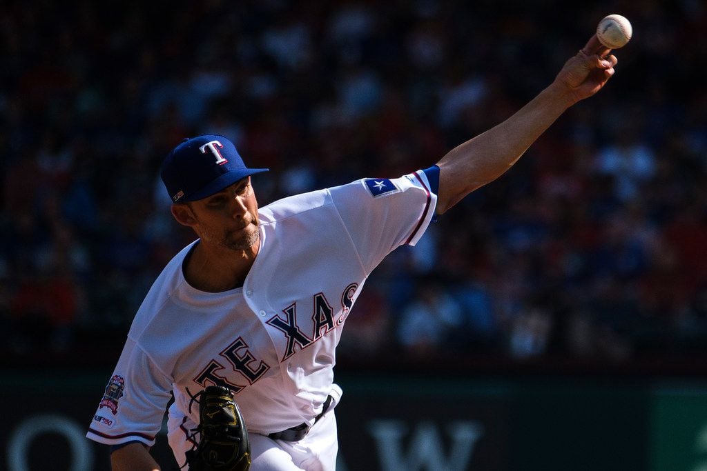 Texas Rangers starting pitcher Mike Minor throws during the fifth inning against the Chicago...