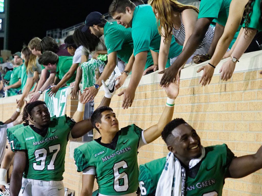 The North Texas team celebrates after they defeat their opponent, Lamar, 59-14, at Apogee...