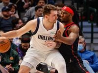 Dallas Mavericks Luka Doncic (77) protects the ball from Toronto Raptors Precious Achiuwa (5) during a game at the American Airlines Center in Dallas on Wednesday, January 19, 2022.