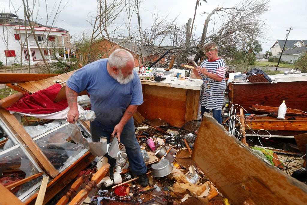 Bill and Paulette Rogers search for the second story of their home his wallet after Hurricane Harvey destroyed their house in Port Aransas, Texas on Aug. 26, 2017.   (Nathan Hunsinger/The Dallas Morning News)