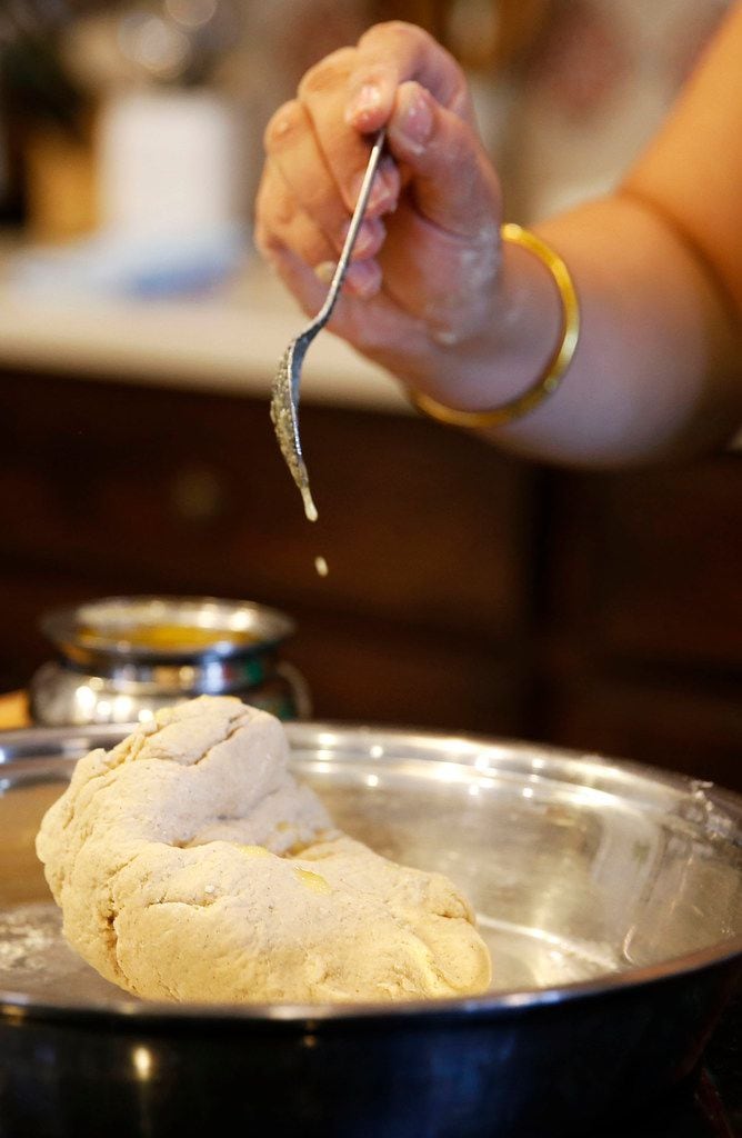 Sapna Punjabi-Gupta drizzles homemade ghee over the dough for the roti.