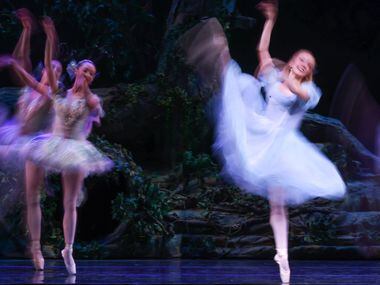 Alice (Alexandra F. Light, right) dances with a swarm of butterflies and dragonflies after...