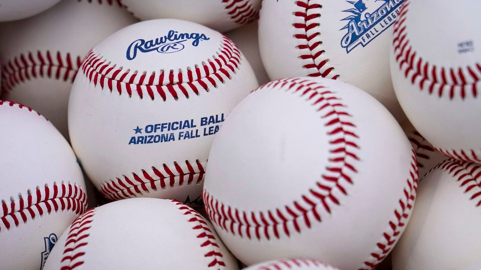A basket of Arizona Fall League balls sits ready for a practice drill during a Texas Rangers...