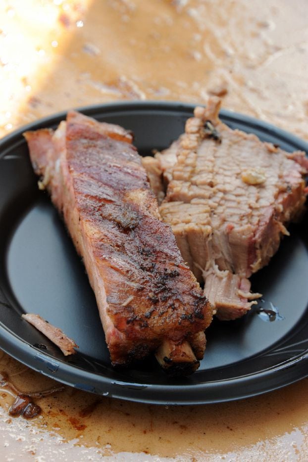 Dallas Fire Department serves smoked ribs and brisket to patrons at Battle of the Pitmasters...