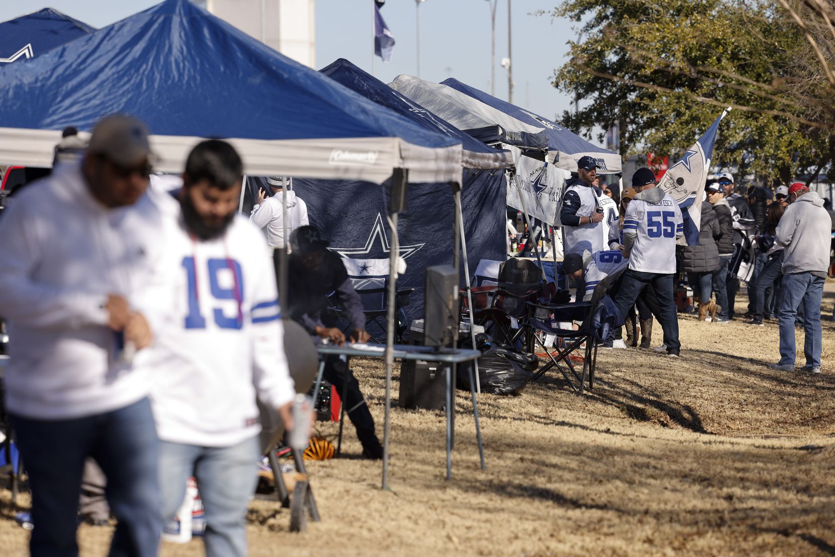 Fans tailgate before an NFL wild-card playoff game between the Dallas Cowboys and the San...